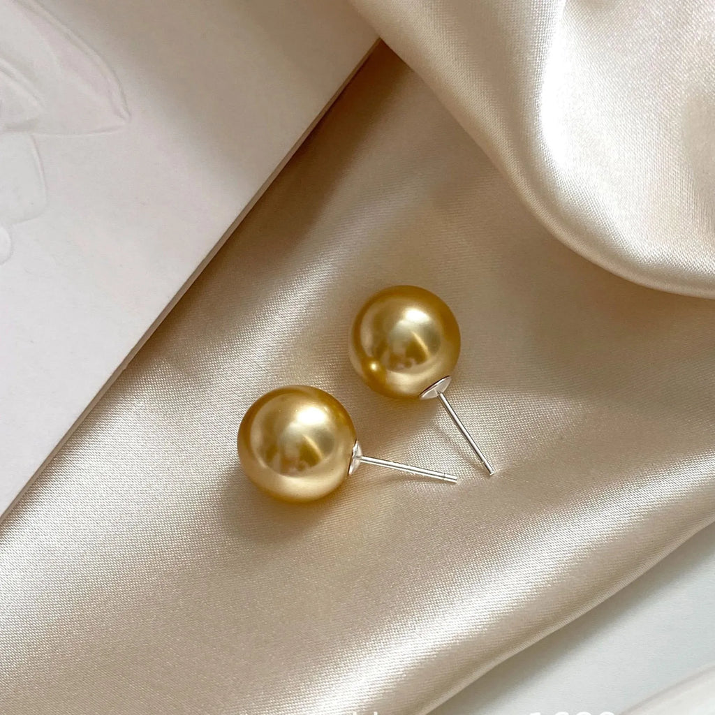 Large geometric pearl stud earrings for women with an eight-point star detail, shown in silver.