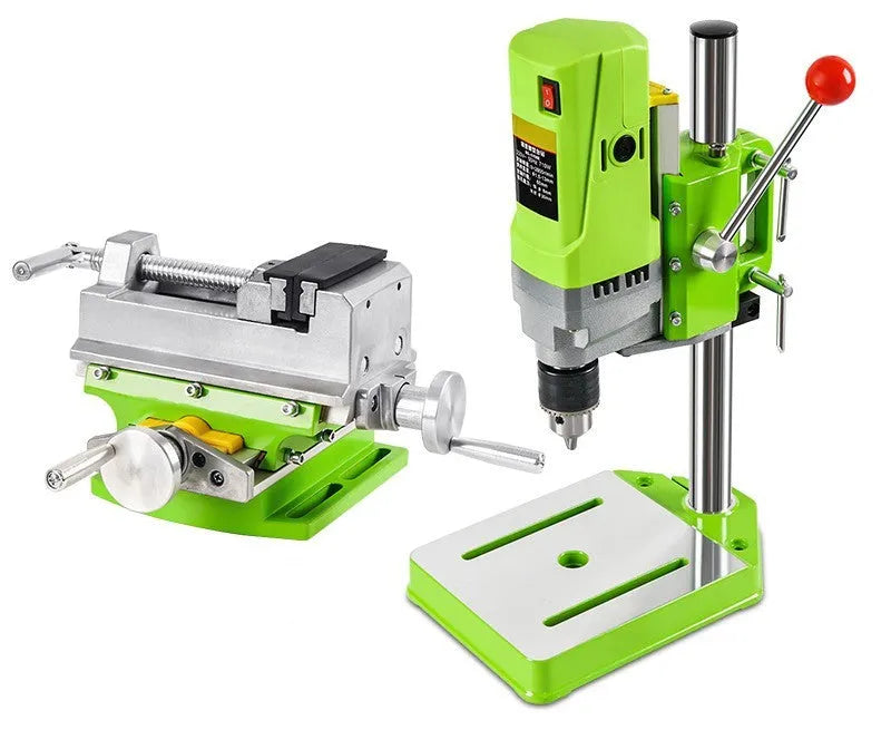 Bench drill milling machine on a workbench with cross bench pliers.