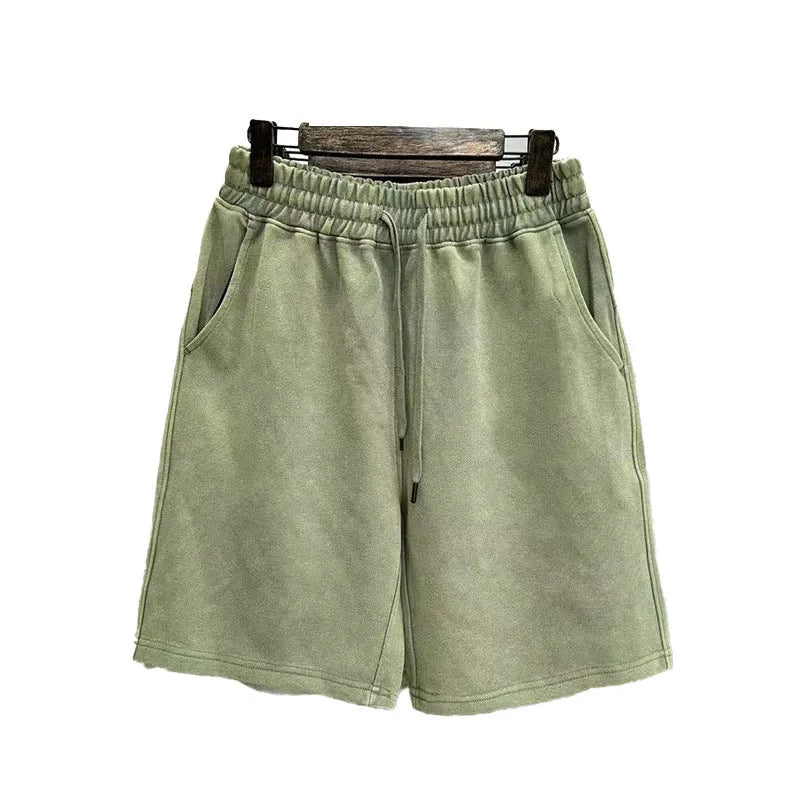 A pair of men's light blue distressed casual cotton shorts with a loose, straight-leg fit on a plain background.