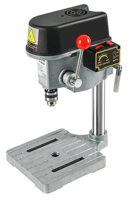 Bench drill milling machine on a workbench with cross bench pliers.