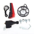 Silver aluminium bicycle dynamo light kit mounted on a bike fork for friction-powered lighting.