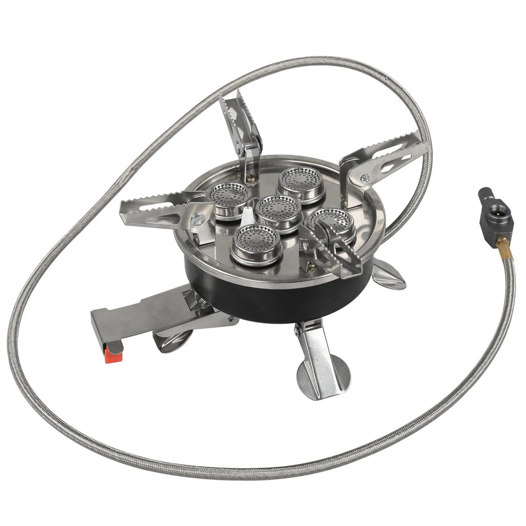 Silver foldable split camping stove with extended gas hose on a grey background