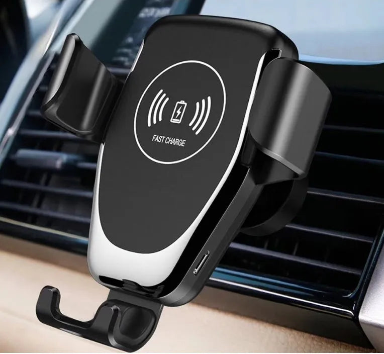 Black car wireless phone charger mounted on a vehicle vent, holding an iPhone.