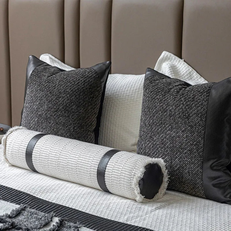 Grey and white plaid bed runner blanket with leather round pillow on 1.5m bed