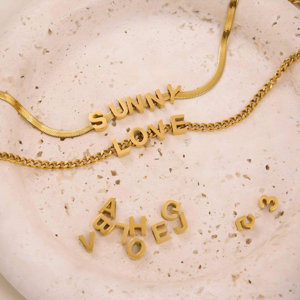 Gold titanium steel necklace with letter A charm on a 40.5cm chain.