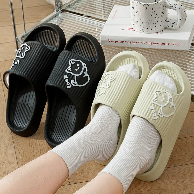 Women's green cat slippers with thick EVA platform sole on a wooden floor