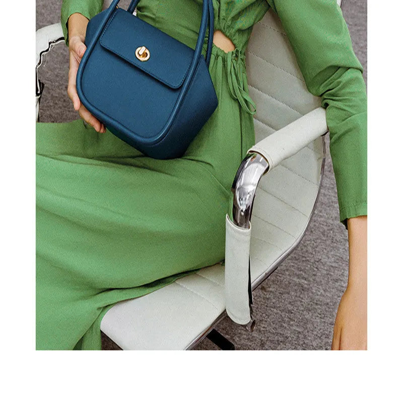 Women's leather wing tote handbag with cross-body strap and hard handle in cow leather
