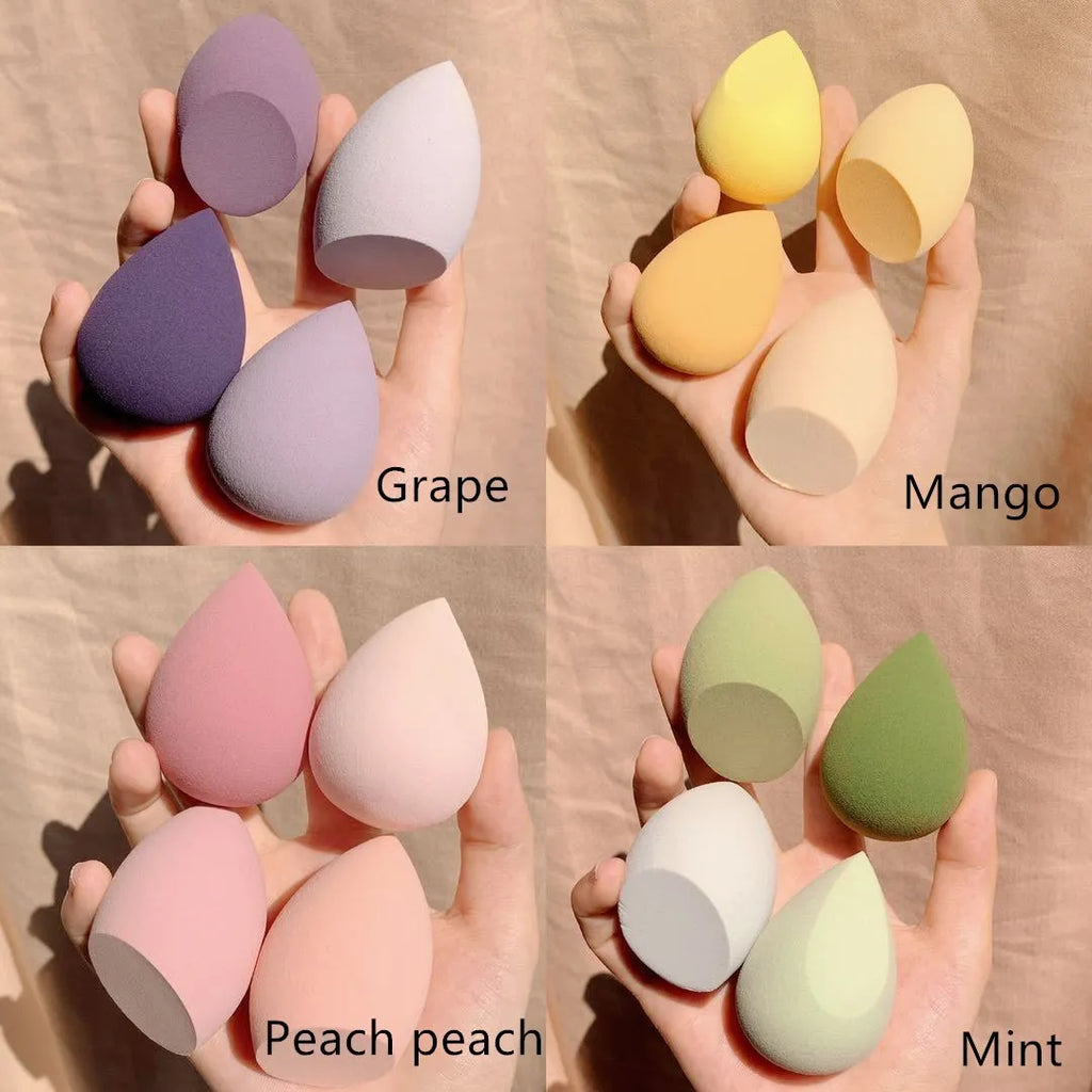 Makeup egg box showing four coloured synthetic sponge applicators: Grape, Mango, Mint, and Peach Peach.