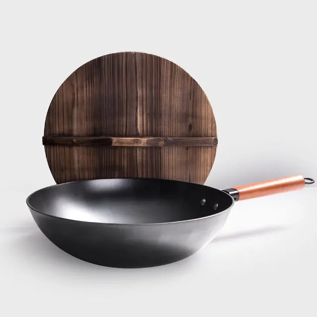Traditional black iron wok with long wooden handle measuring 32cm diameter