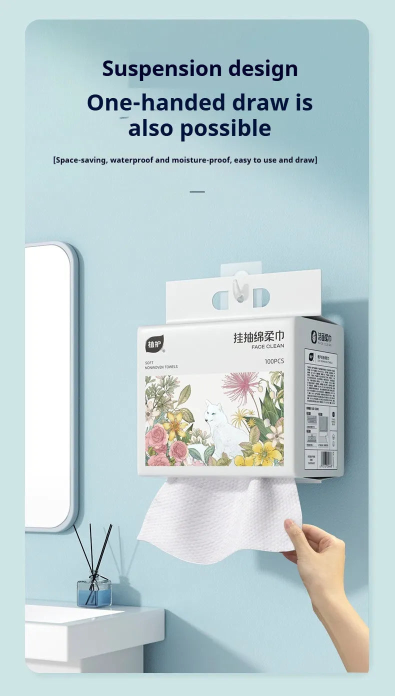 A roll of disposable white face cloths with a removable hook for hanging storage.