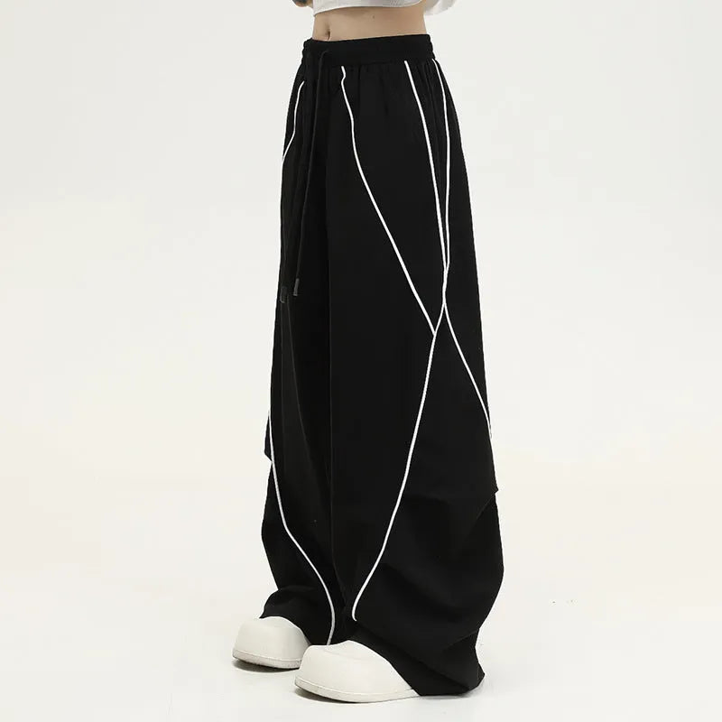 Black pleated wide-leg hip hop trousers with a striped pattern on a mid waist.