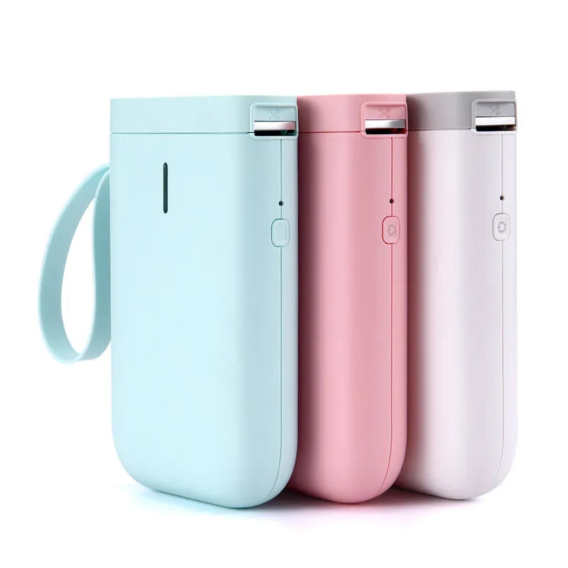 Compact D11 Bluetooth thermal label printer in black, white, pink, or green with smartphone showing label design app.