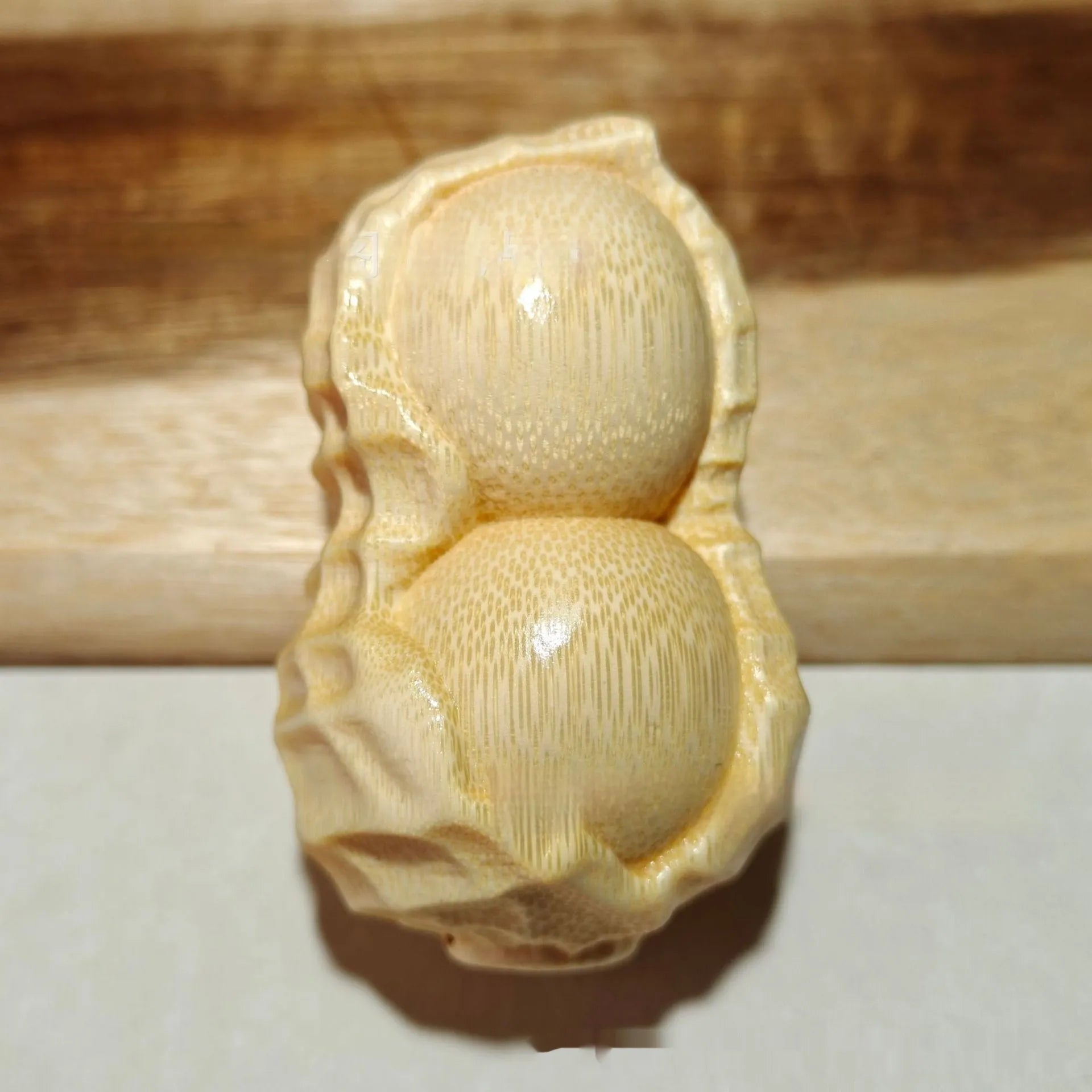 Natural solid bamboo peanut ornament with carving detail and modern simple style
