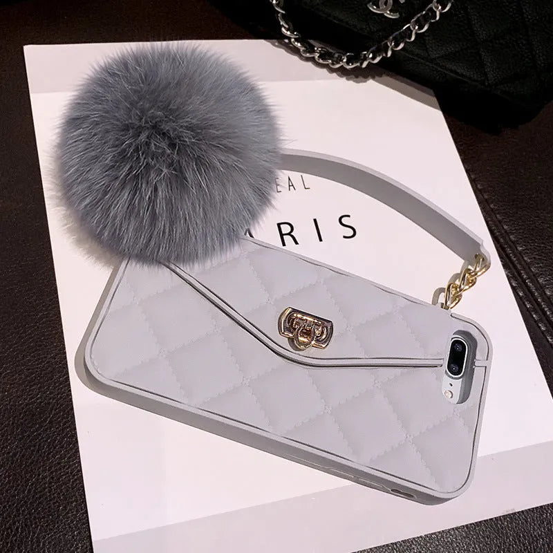 TPU iPhone mobile case with plush hairball grid texture in dark green, shown on a phone.