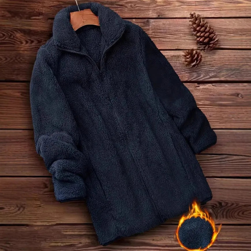 Man wearing a double-sided black fleece jacket with a velvet texture.