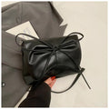 Women's black PU leather crossbody bag with a horizontal square shape and crossbody strap