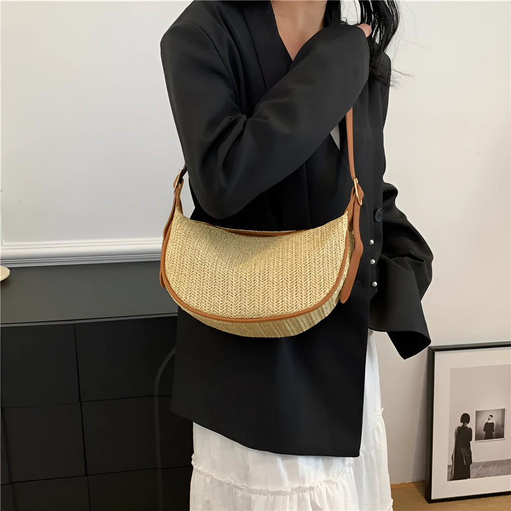 Women's straw woven crossbody bag showing internal phone and file compartments