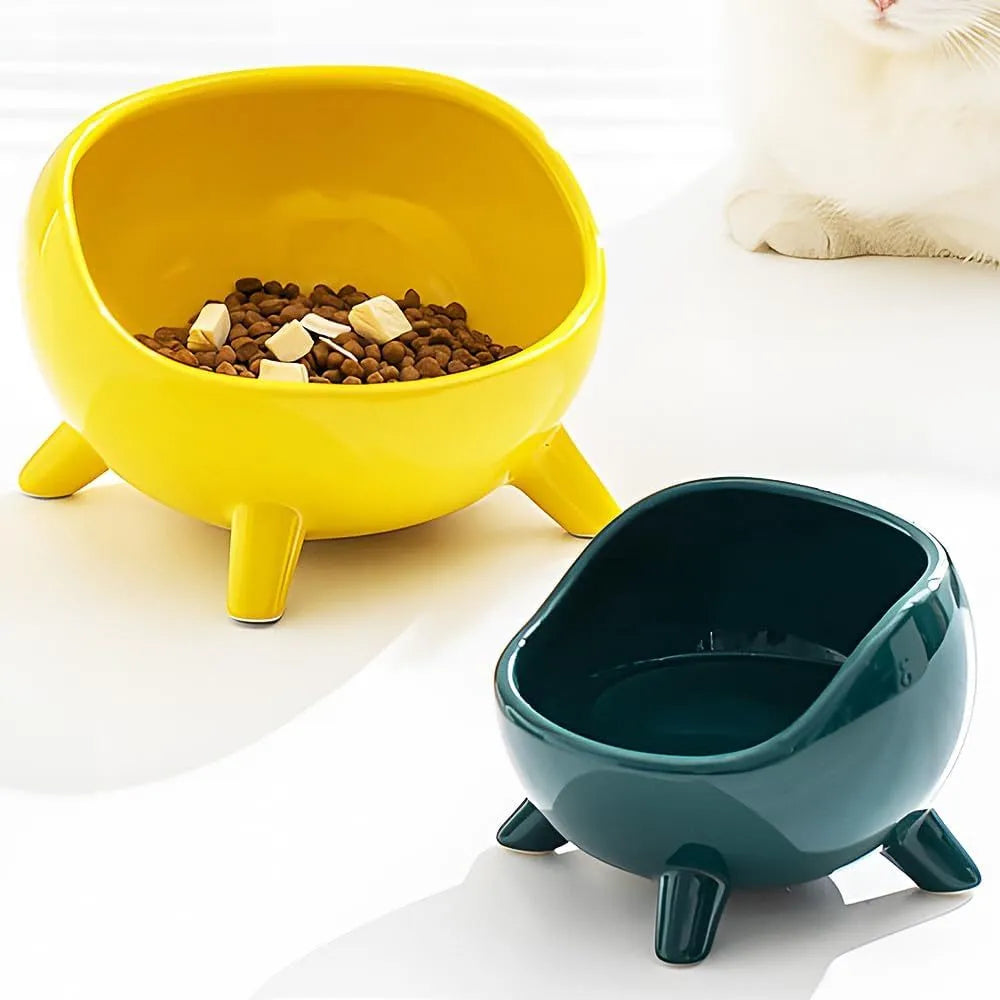 Green four-legged ceramic pet bowl for cats and small dogs on floor