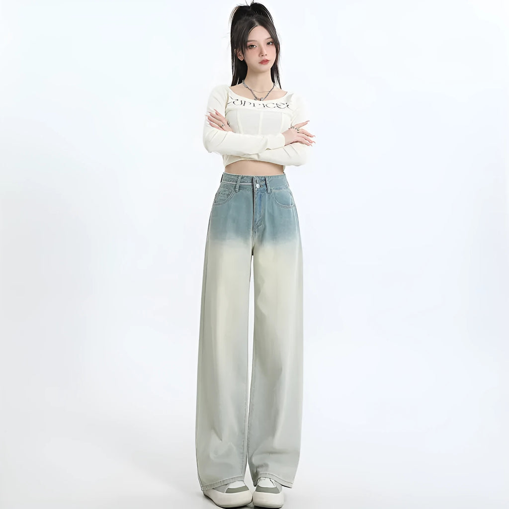 Women's gradient blue denim straight-leg wide-leg trousers laid flat, showing colour fade.