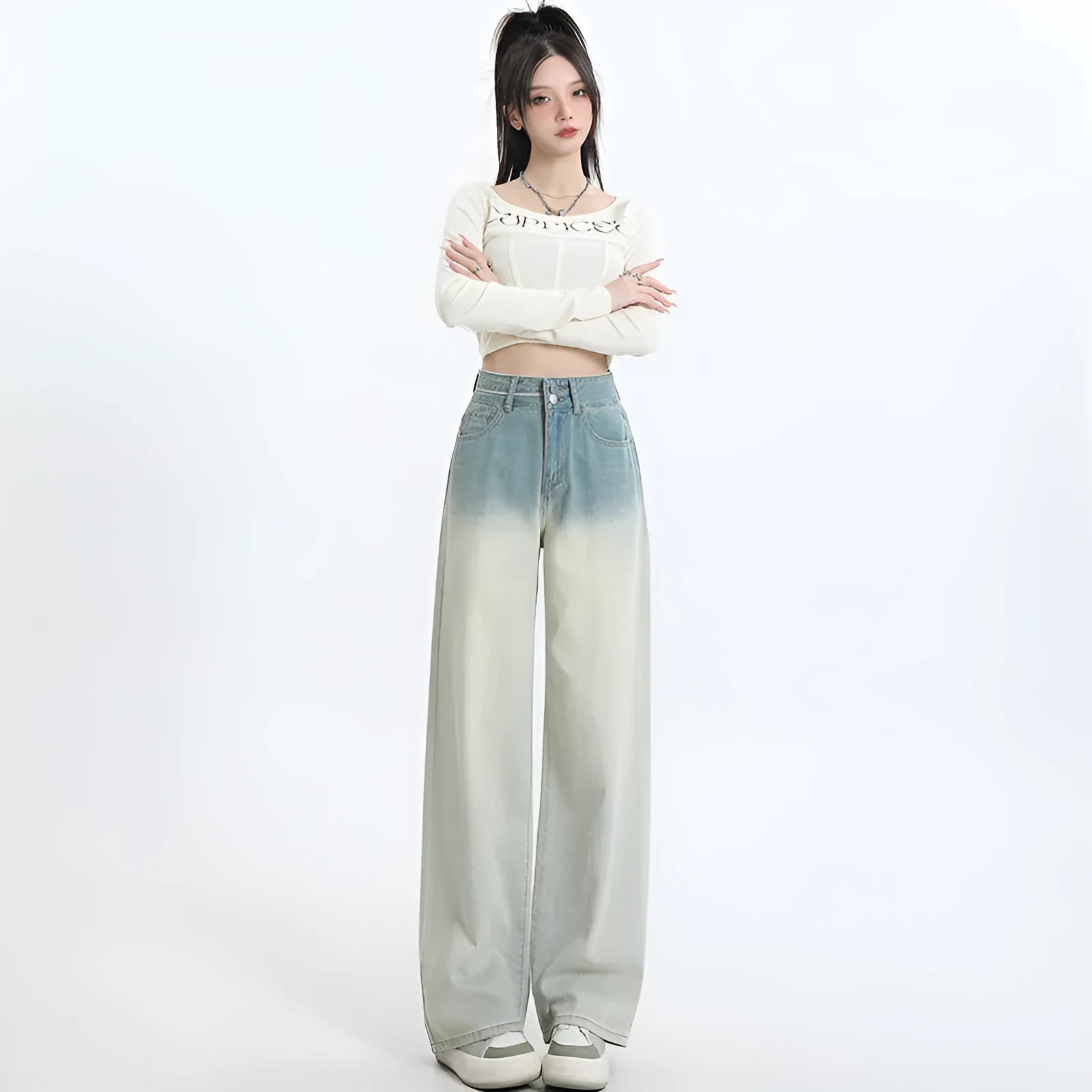 Women's gradient blue denim straight-leg wide-leg trousers laid flat, showing colour fade.