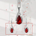 Black and red alloy water droplet pendant necklace and matching earrings jewellery suite.