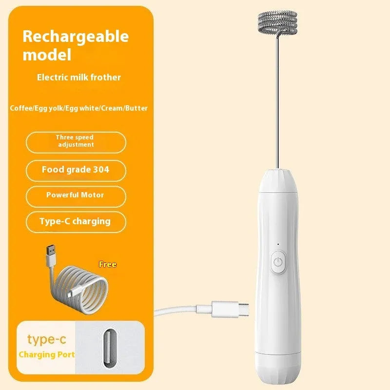 Compact black handheld milk frother with stainless steel whisk on a kitchen counter.