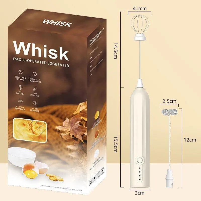 Compact black handheld milk frother with stainless steel whisk on a kitchen counter.