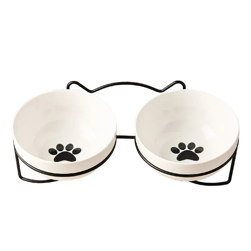 White ceramic cat bowl with decorative pattern and black iron frame support