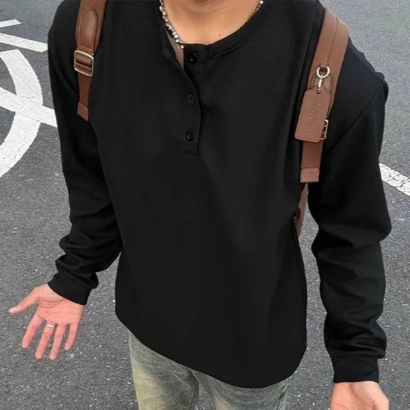 Men's black long-sleeved pullover top with Henry collar in loose fit for daily wear