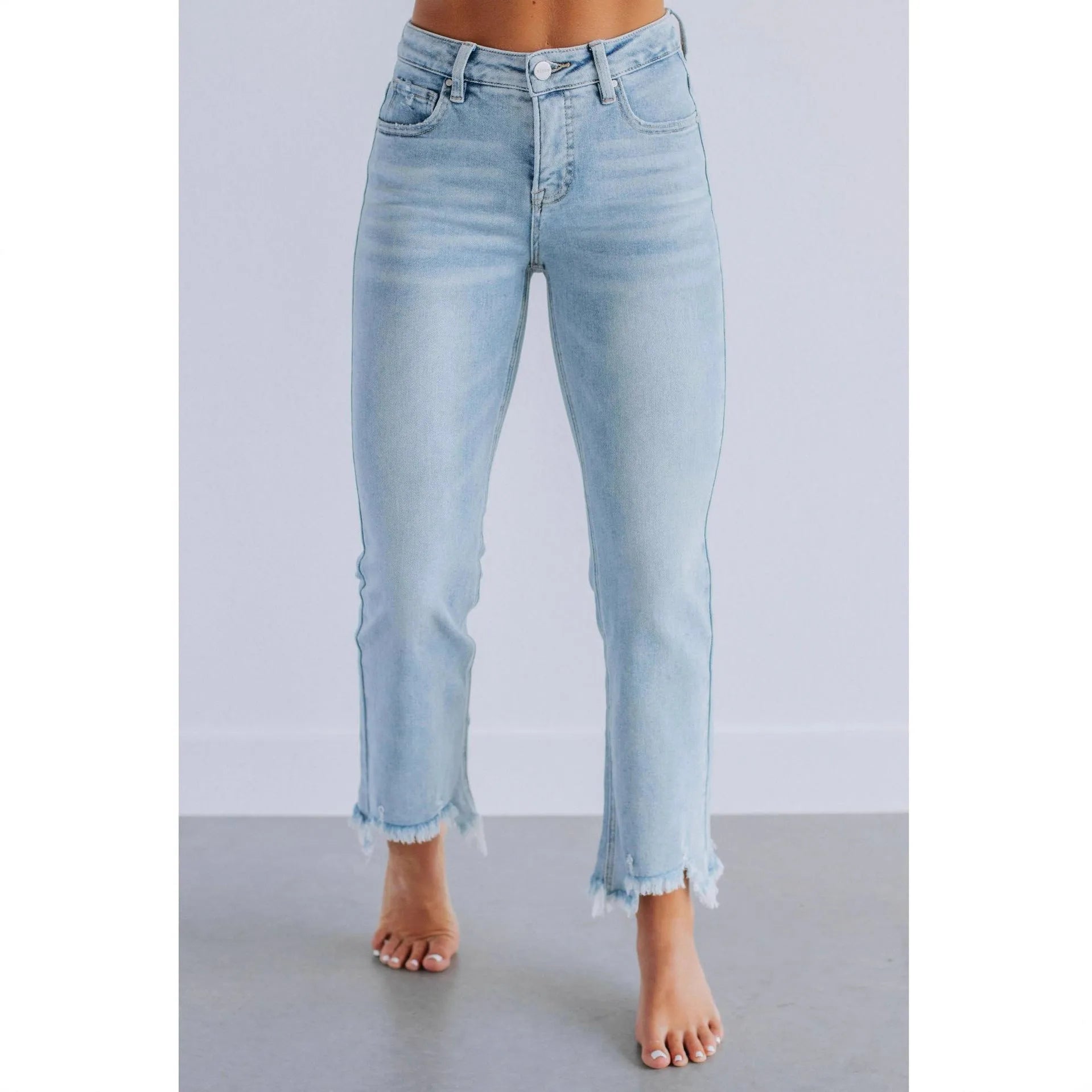 Women's solid blue denim trousers with a casual, hand-worn finish on a hanger.