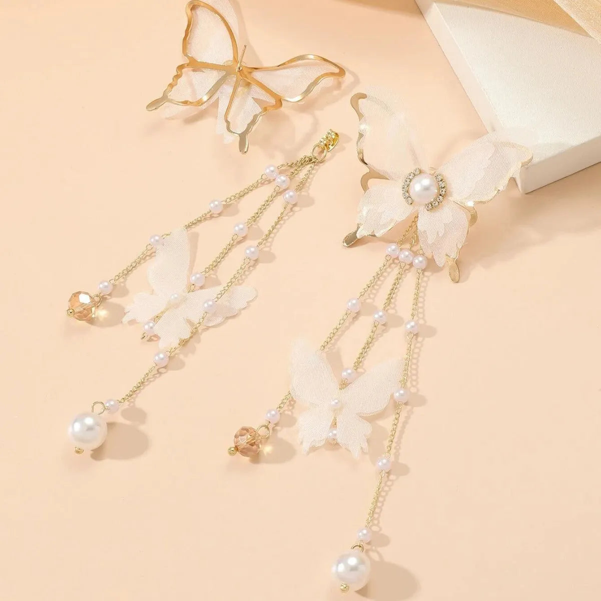 White butterfly earrings with lace details, tassels, rhinestones and pearls on copper alloy