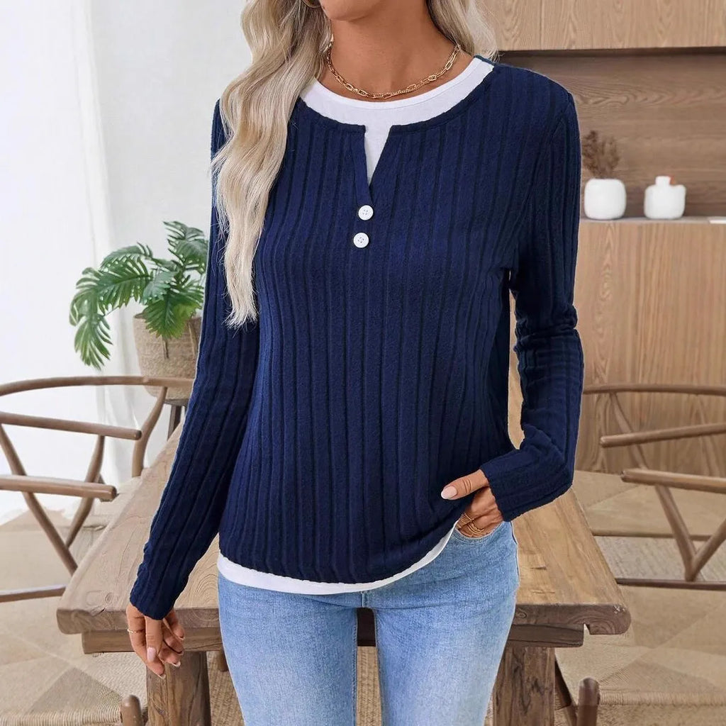 Women's black fake two-piece round neck button pullover sweater with long sleeves on a hanger.