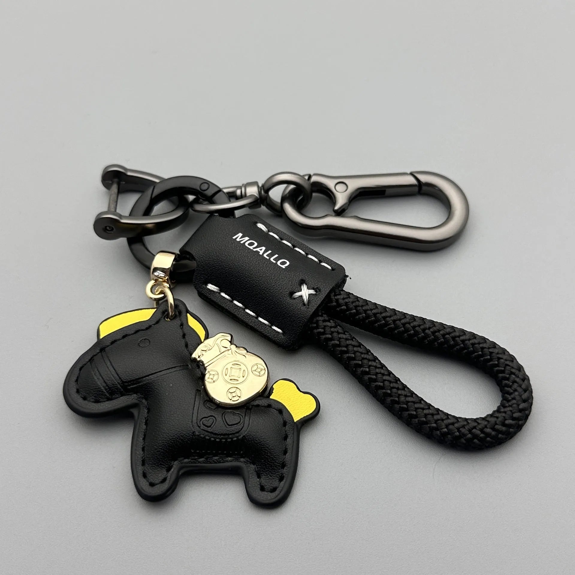 Handmade brown cowhide key pendant with a green flannel rope and a gold-toned horse-shaped buckle.