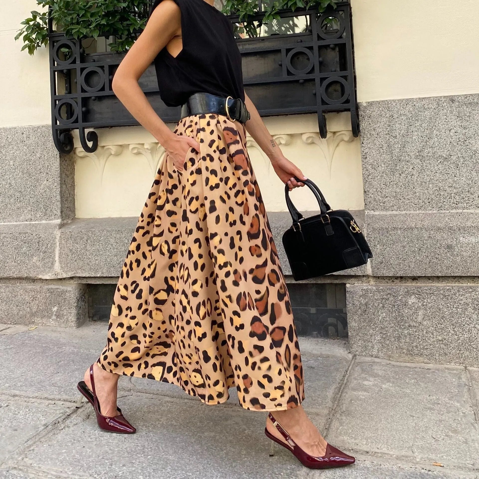 Brown leopard print women's A-line long skirt with a large hemline, shown on a model.
