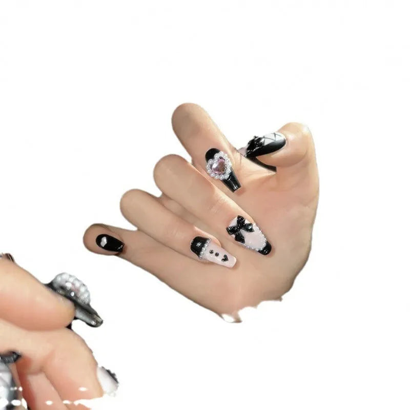 Black pink heart shape hand-painted false nails with bow designs in plastic armour suit