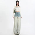 Women's gradient blue denim straight-leg wide-leg trousers laid flat, showing colour fade.