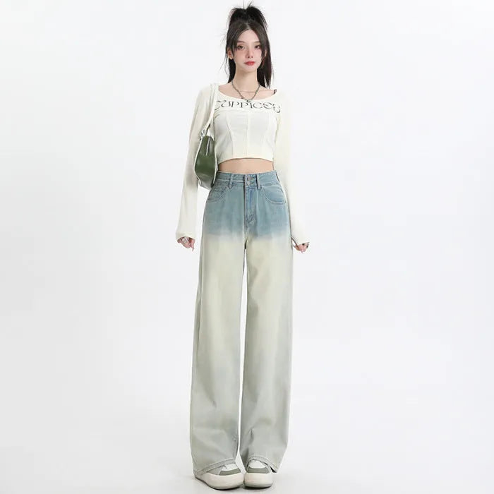 Women's gradient blue denim straight-leg wide-leg trousers laid flat, showing colour fade.