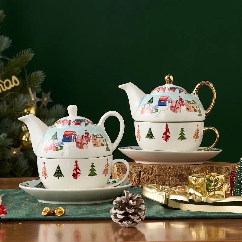 Ceramic gold-plated Christmas teapot set with snowflake design, including pot on dish and cup on dish with spoon, in gift box.