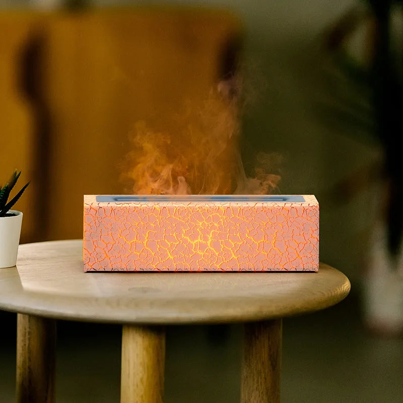Square-shaped lava lamp-style USB aroma diffuser humidifier with colourful flame light effect on a desk.