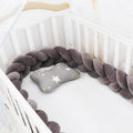 Baby crib bumper braid knot pillow cushion in spandex velvet, shown in a light grey colour