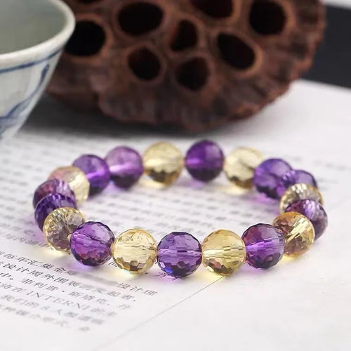 Close-up of a 128-facet cut crystal ametrine bracelet with detailed bead modelling on a wrist.