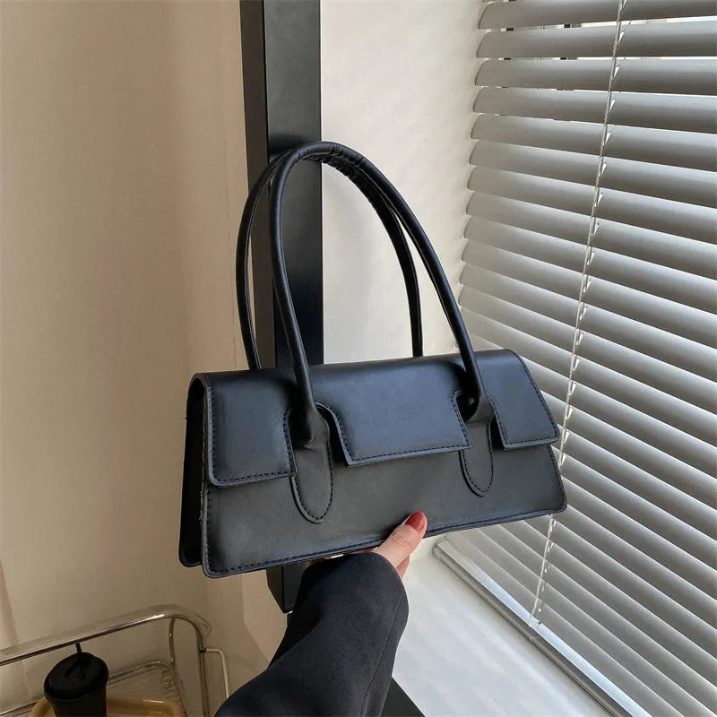 Women's retro style small square shoulder bag in four colours with adjustable strap and stitching detail