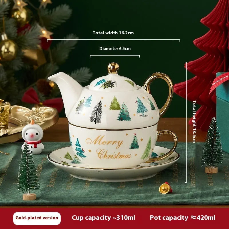 Ceramic gold-plated Christmas teapot set with snowflake design, including pot on dish and cup on dish with spoon, in gift box.