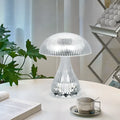Small white touch-control night lamp with USB charging cable on wooden surface