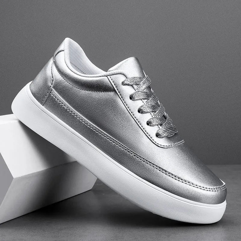 Women's white leather flat casual shoes with lace-up front on a plain background