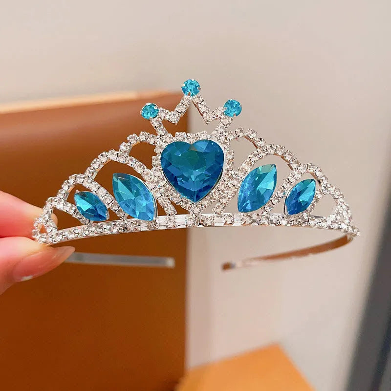 Children's electroplated alloy crown headband with pink crystals, shown on a model for scale.