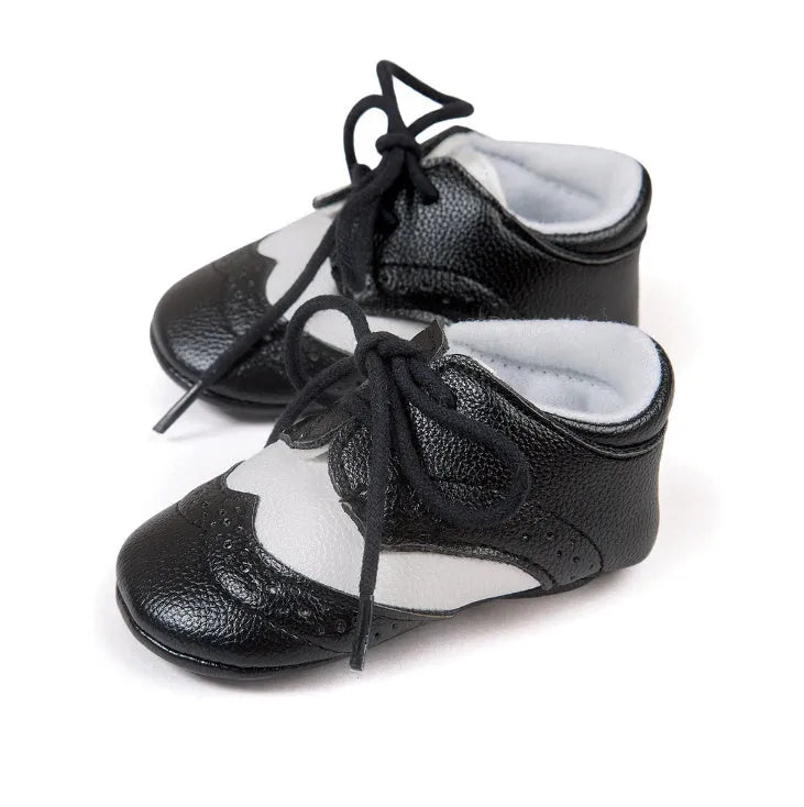 Vintage style baby walking shoes with soft soles and synthetic leather uppers in multiple colours