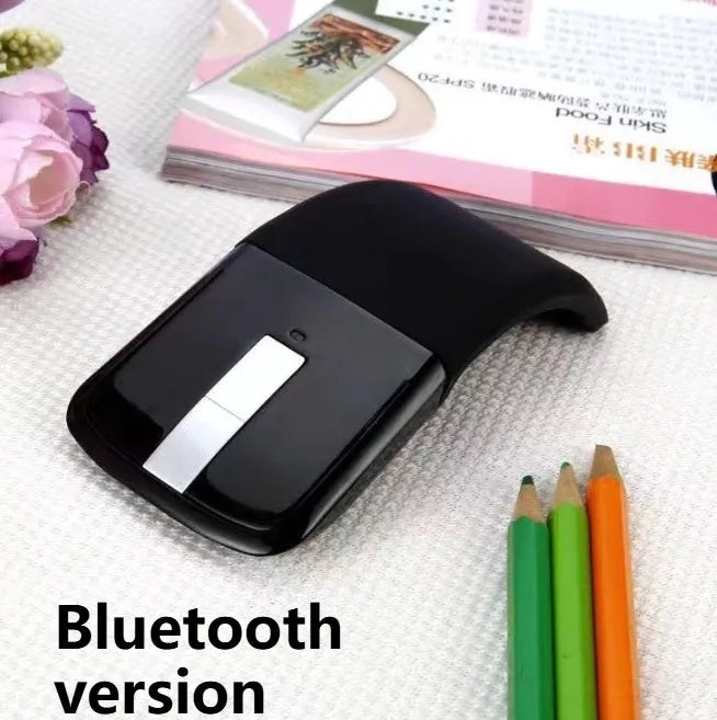Folding wireless Bluetooth mouse showing compact design with touch surface and portable folded position