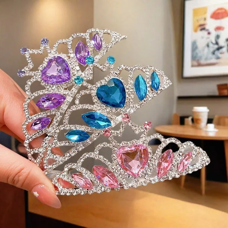 Children's electroplated alloy crown headband with pink crystals, shown on a model for scale.