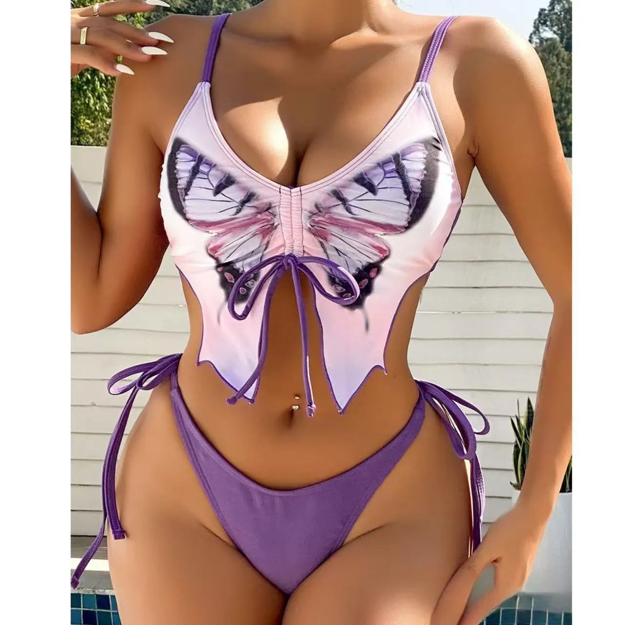 Women's purple bikini suit with bow ins style detail on a split design, made from polyester fabric.